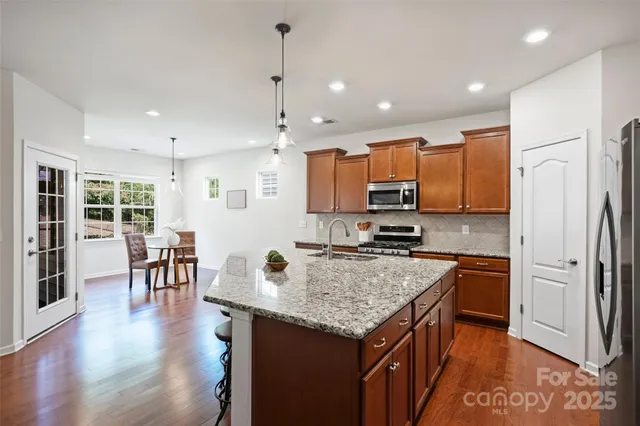 a kitchen with a center island appliances and cabinets