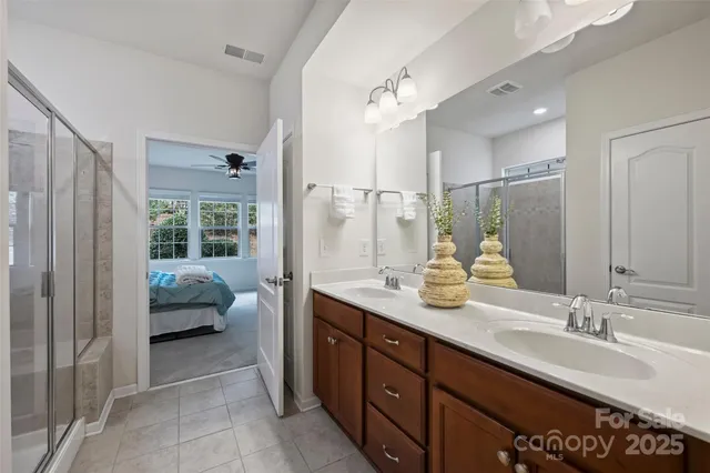 a en suite bathroom with double sink and a mirror
