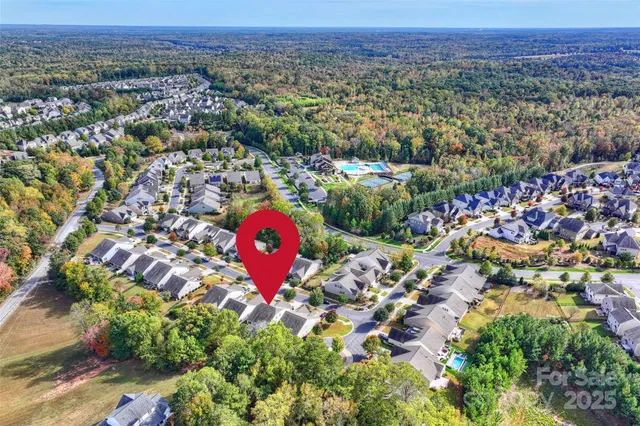 an aerial view of a house with a yard and lake view