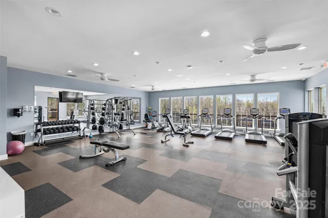 a view of a room with gym equipment and floor to ceiling window