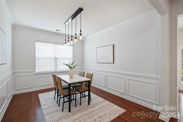 a view of a dining room with furniture and window