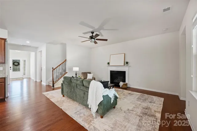 a living room with furniture a fireplace and a chandelier
