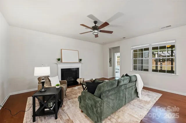 a living room with furniture a fireplace and a window