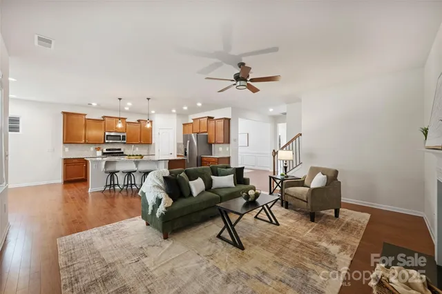 a living room with furniture and kitchen view