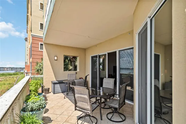 a building outdoor space with patio furniture and potted plants