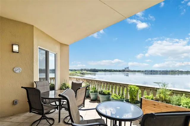 a balcony with furniture and wooden floor