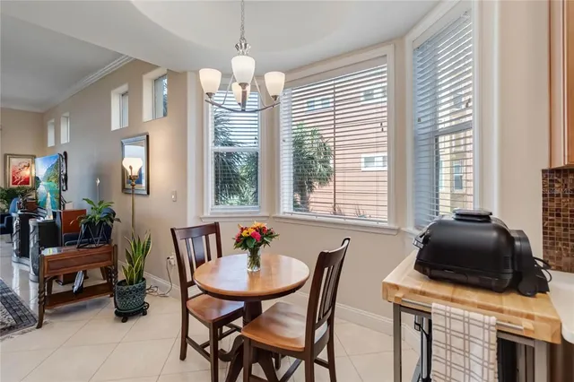 a view of a dining room with furniture and a chandelier