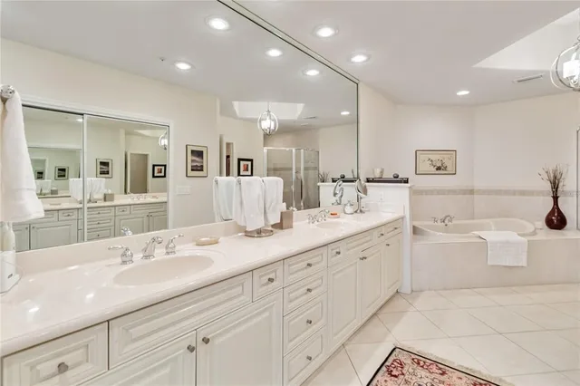 a bathroom with a double vanity sink mirror and