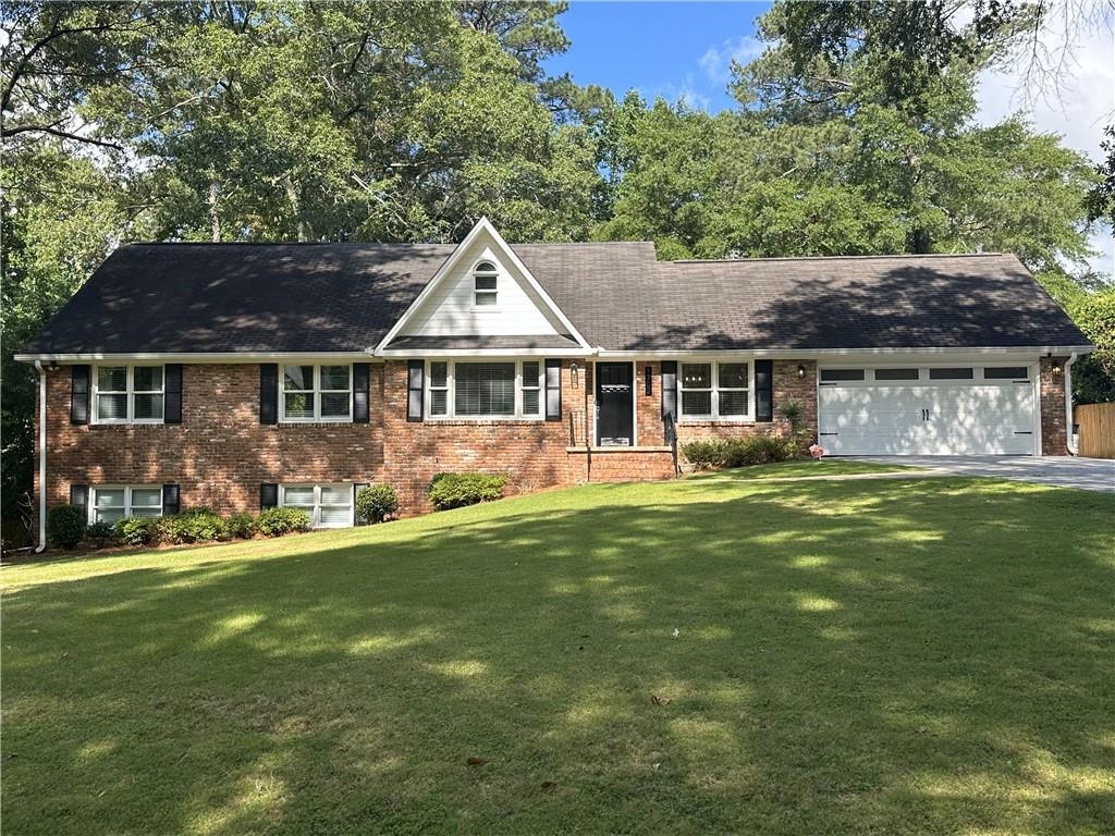 1702 Montcliff Court Decatur, GA 30033 - Photo 1 of 1 a front view of a house with a garden
