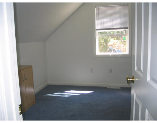 59 Ferris Street Springfield, MA 01151 - Photo 6 of 9 a view of empty room with wooden floor and fan