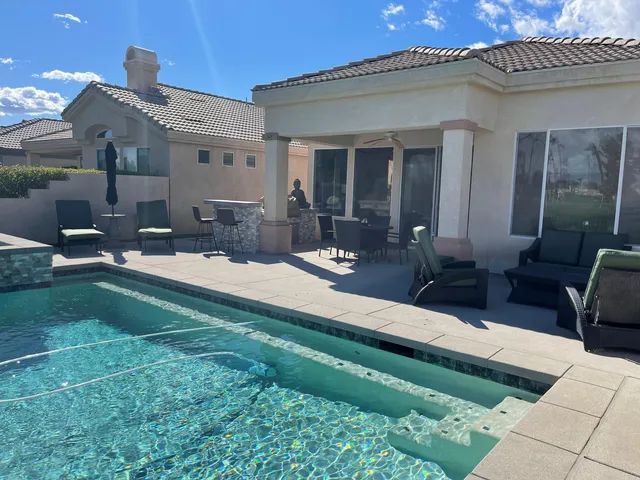 a living room with furniture a fireplace and a large window