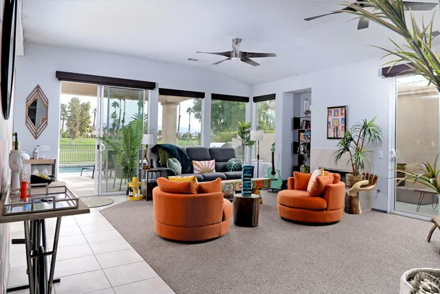 a living room with fireplace furniture and a flat screen tv
