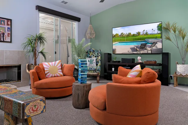 an outdoor living room with furniture and wall painting