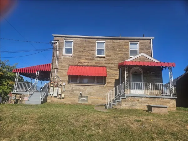 a front view of a house with a yard