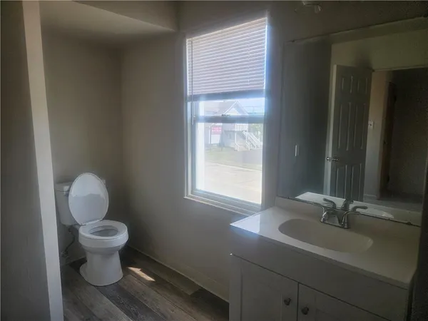a bathroom with a toilet sink and mirror