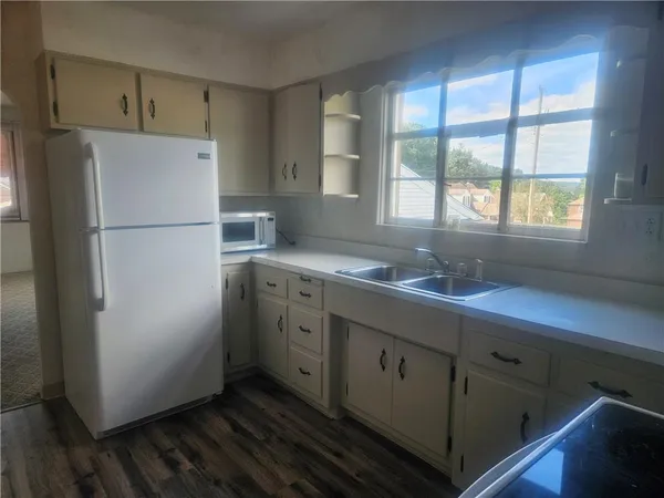 a white refrigerator freezer sitting inside of a kitchen