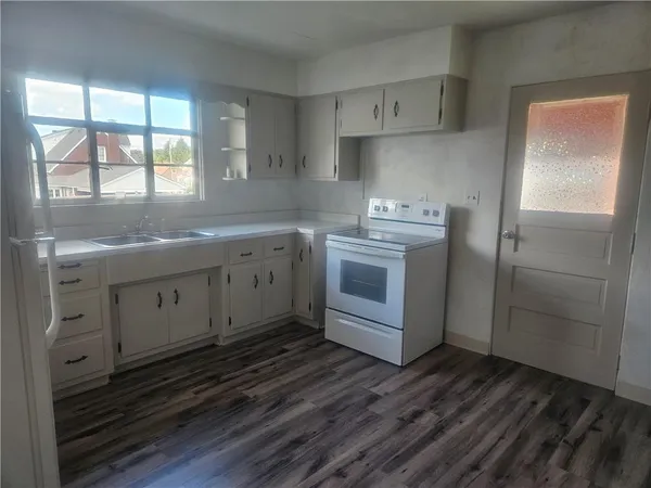 a kitchen with a sink stove and refrigerator