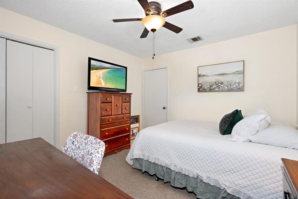 930 Vail Highlands Circle Hewitt, TX 76643 - Photo 20 of 33 a bedroom with a bed and a flat screen tv