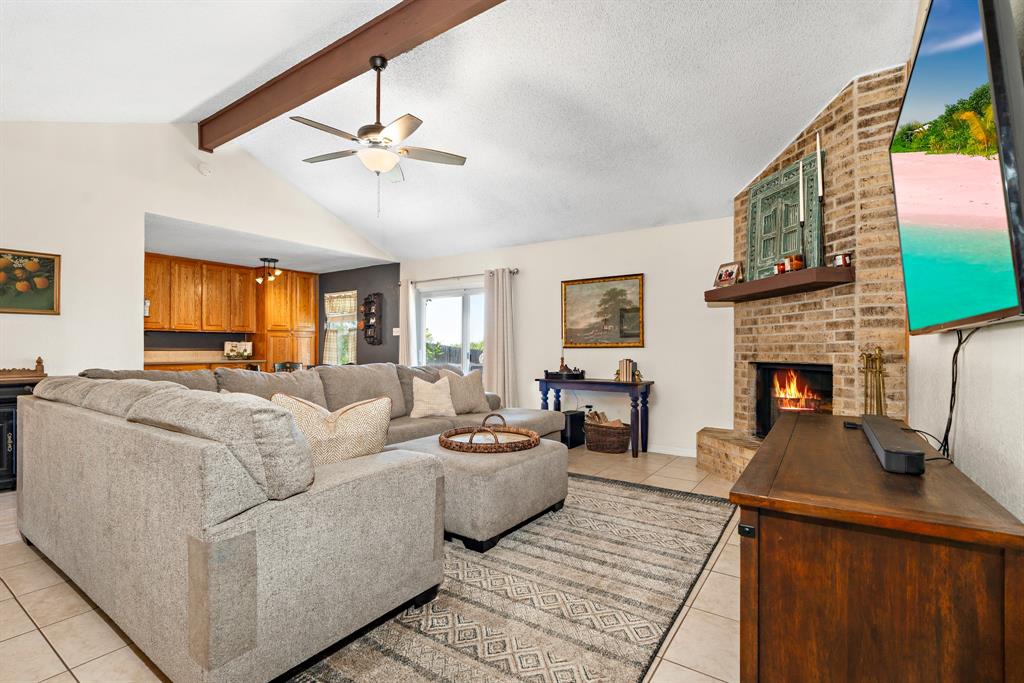 930 Vail Highlands Circle Hewitt, TX 76643 - Photo 8 of 33 a living room with furniture a fireplace and a flat screen tv