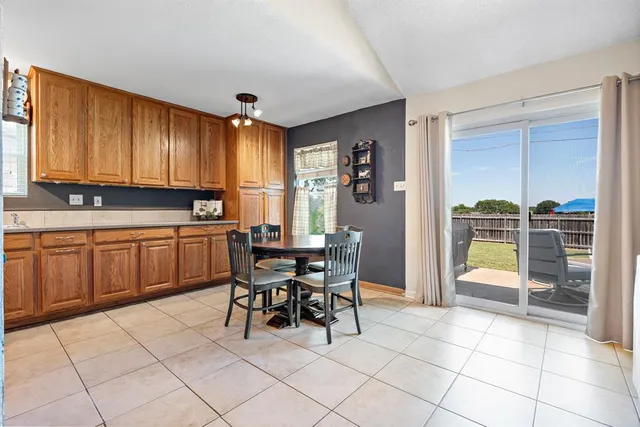 a view of a dining room with furniture and a kitchen