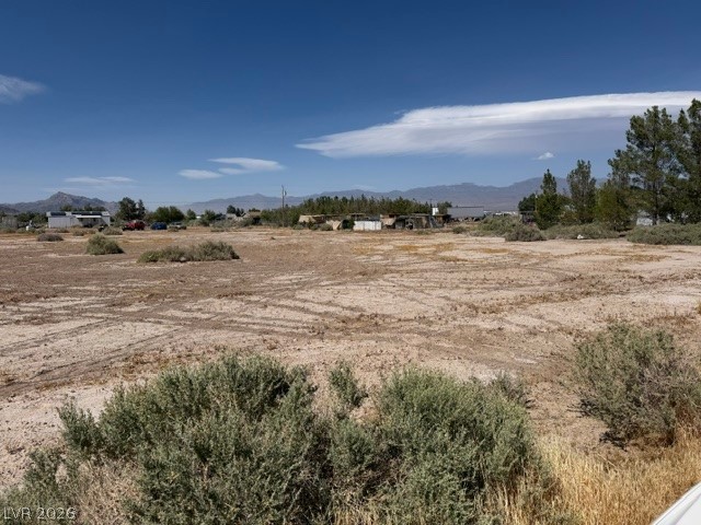 Vast desert lot with distant mountain views, ready for your vision.