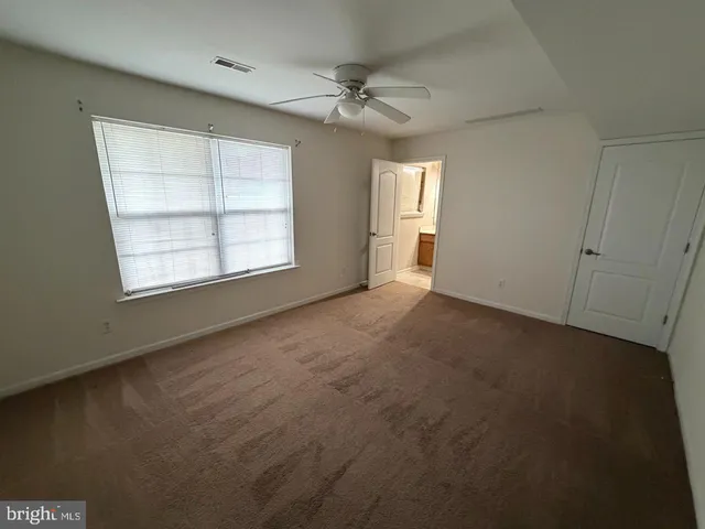 a white toilet sitting next to a bath tub