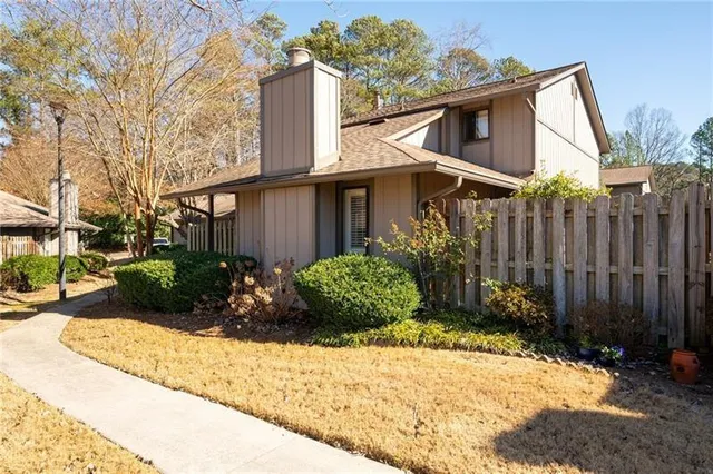 a view of a house with a small yard and plants