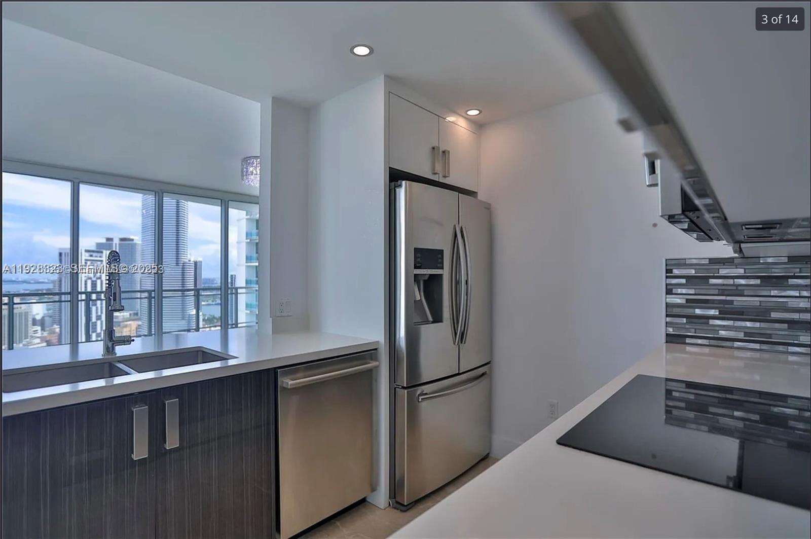 90 Southwest 3rd Street, Unit 3604 Miami, FL 33130 - Photo 3 of 13 a kitchen with stainless steel appliances a refrigerator and a sink