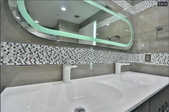a bathroom with a bathtub and a mirror