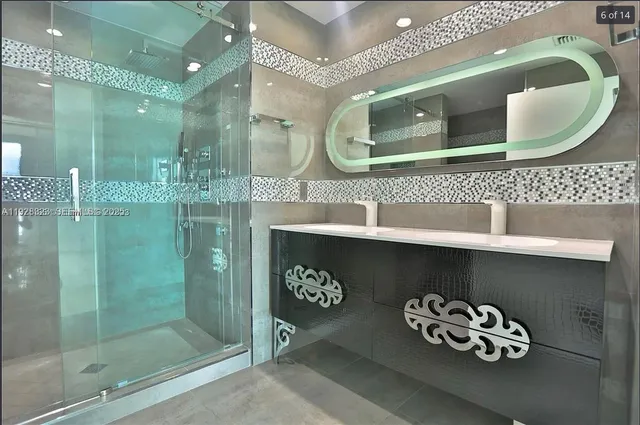 a bathroom with a sink mirror and vanity