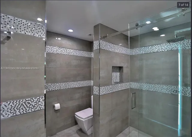 a bathroom with a shower and a toilet