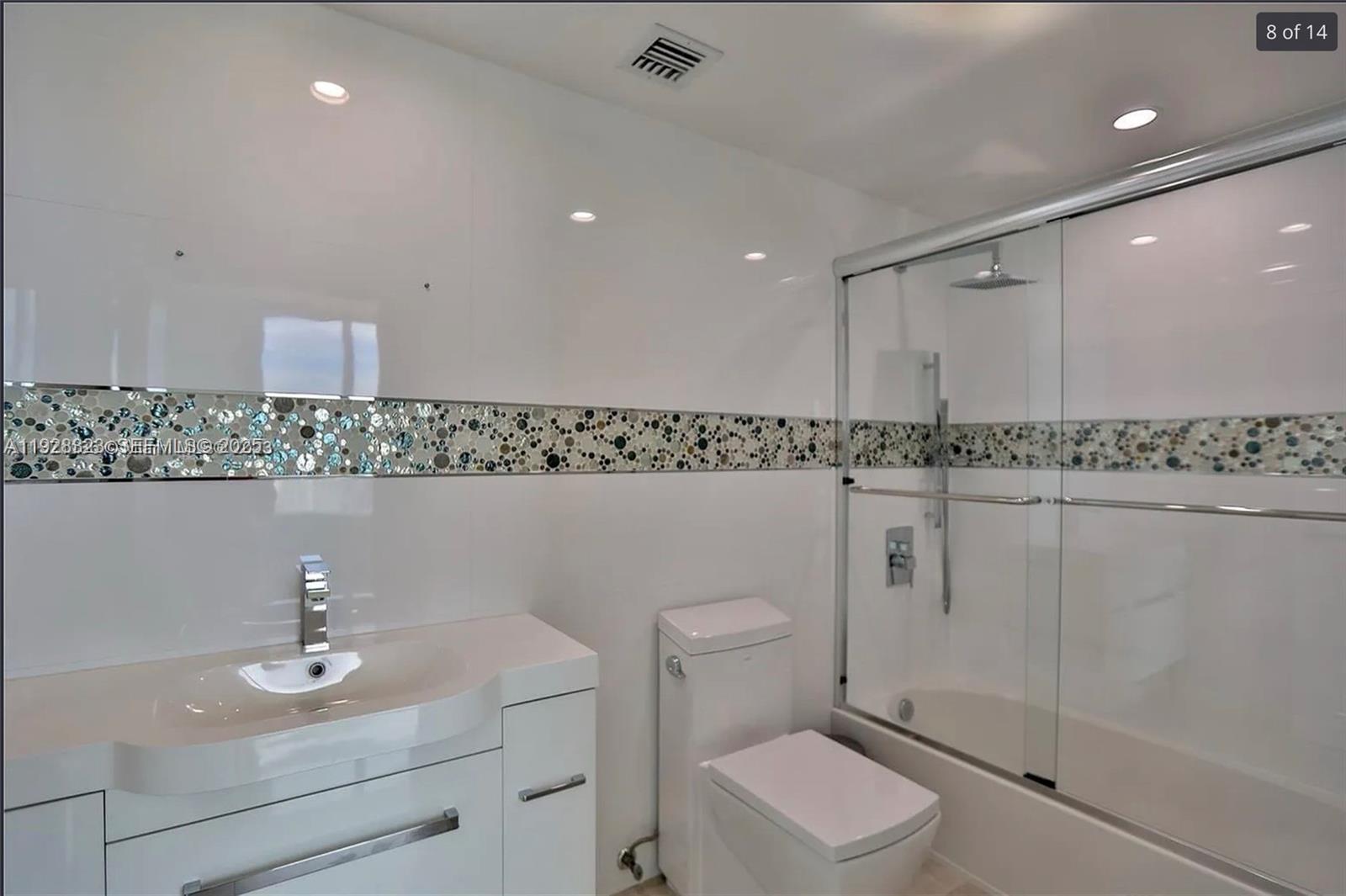 90 Southwest 3rd Street, Unit 3604 Miami, FL 33130 - Photo 8 of 13 a bathroom with a sink a toilet and mirror