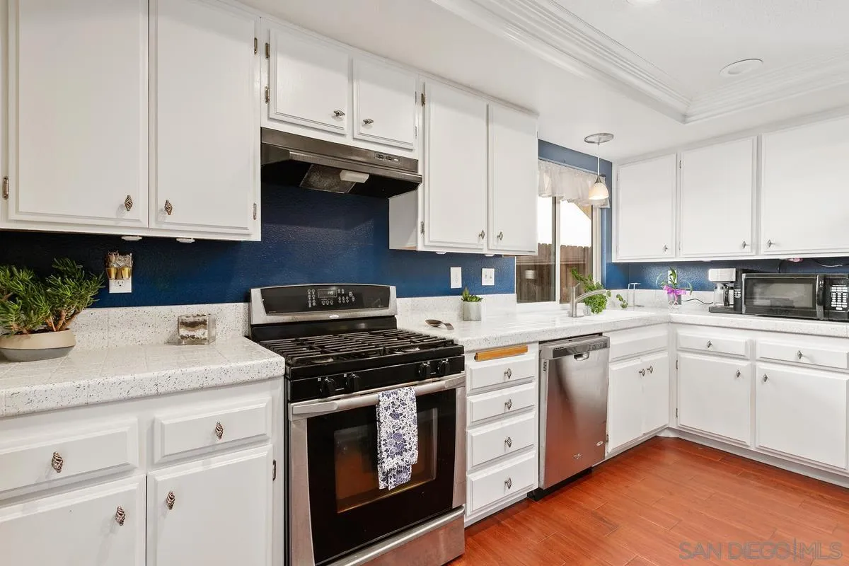 339 Holiday Way Oceanside, CA 92057 - Photo 11 of 20 a kitchen with cabinets appliances a sink and a counter top space
