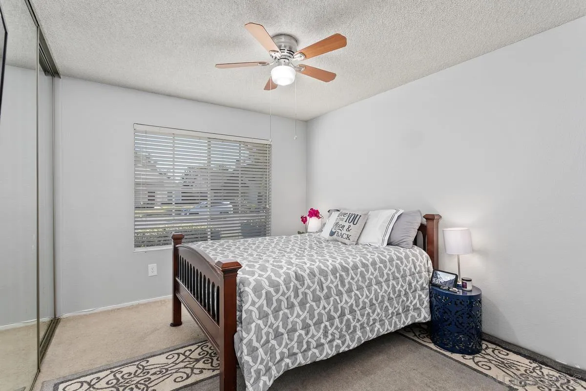 339 Holiday Way Oceanside, CA 92057 - Photo 16 of 20 a bedroom with a bed and a table in it