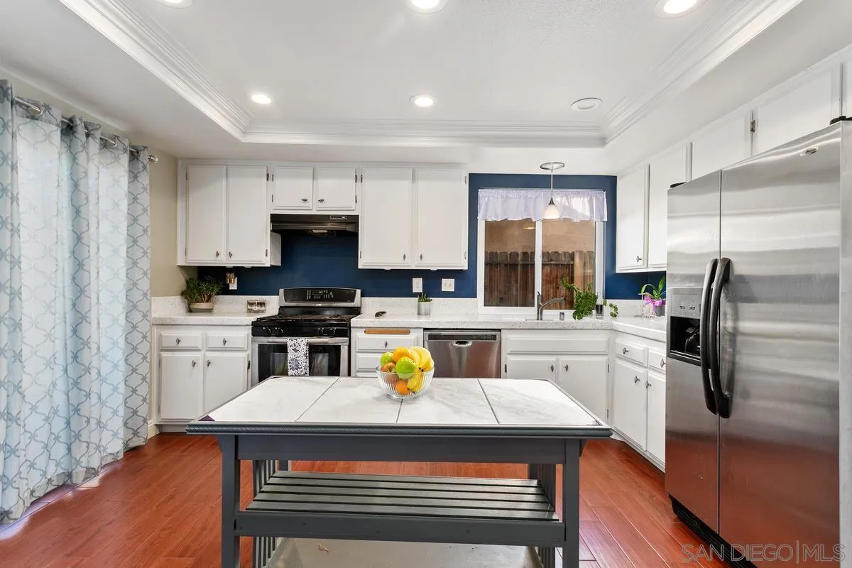 339 Holiday Way Oceanside, CA 92057 - Photo 10 of 20 a kitchen with a refrigerator and a stove top oven
