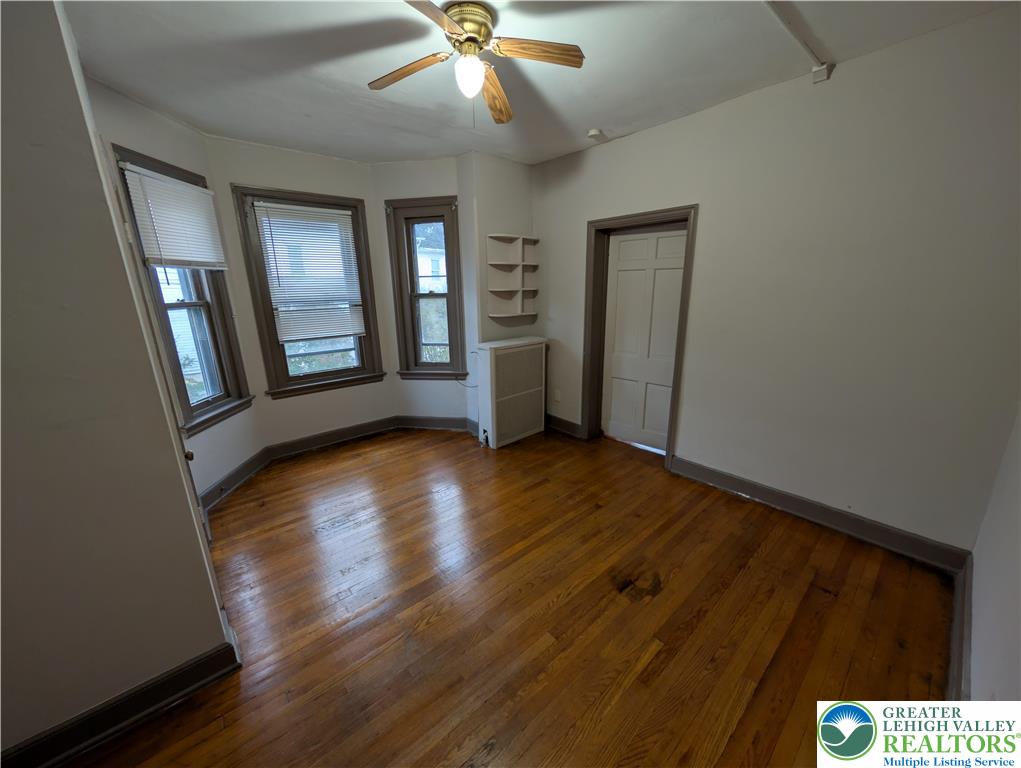 426 Carlton Avenue, Unit 2 Bethlehem, PA 18015 - Photo 12 of 18 a view of an empty room with wooden floor and a window