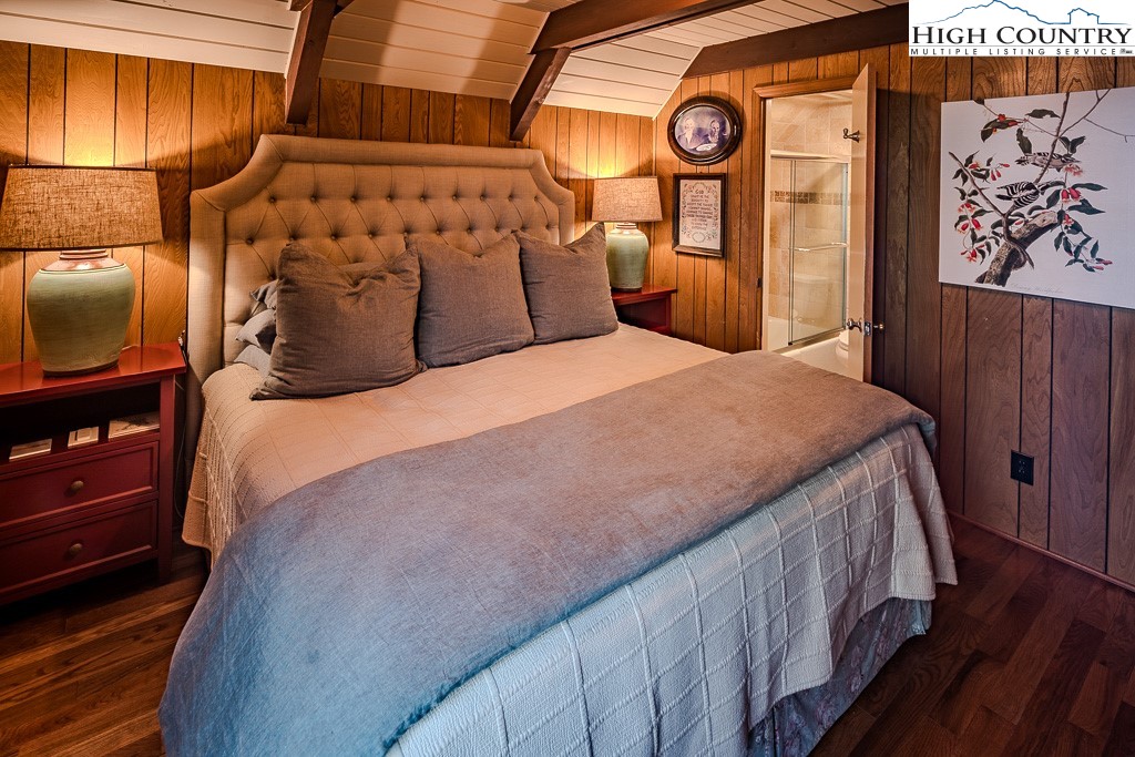 335 Cherry Drive Boone, NC 28607 - Photo 15 of 32 a bed sitting in a bedroom next to a window