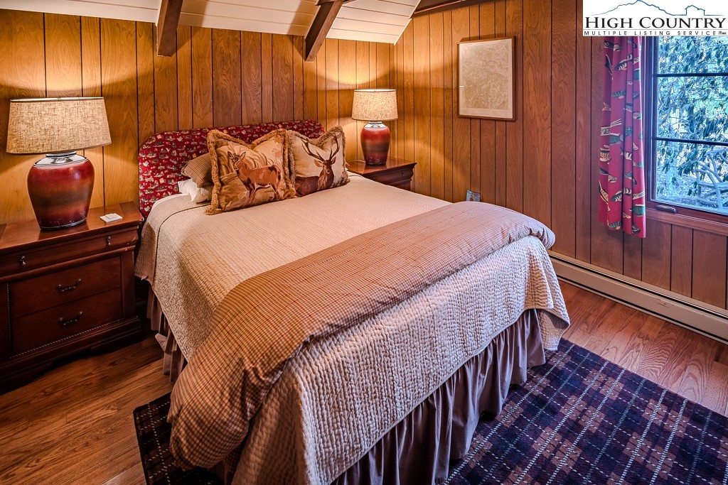 335 Cherry Drive Boone, NC 28607 - Photo 17 of 32 a bedroom with a bed and wooden floor