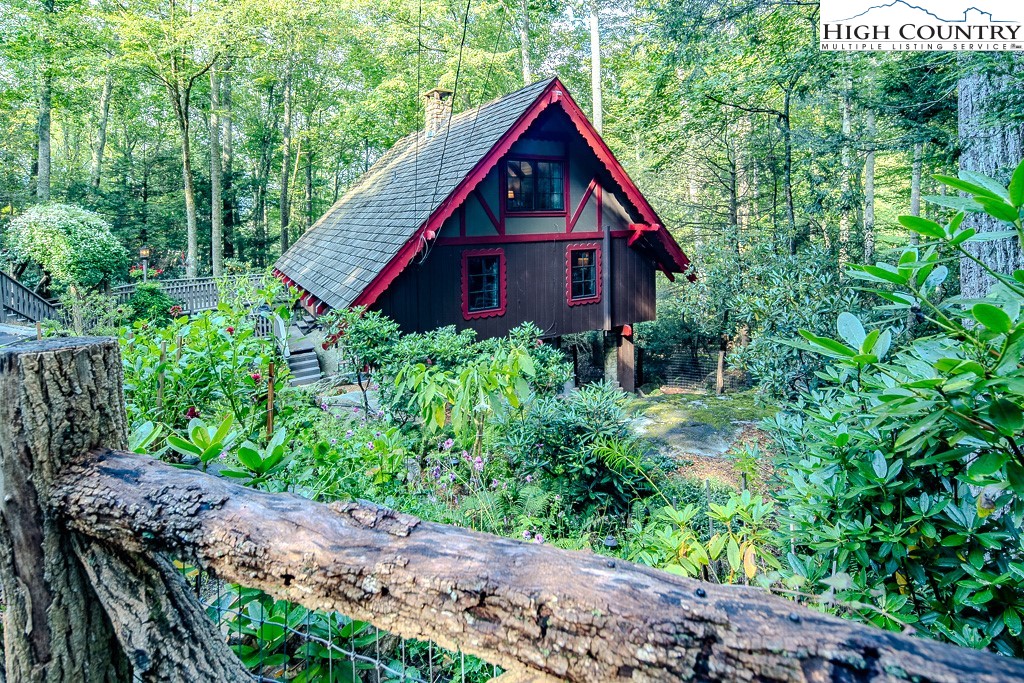 335 Cherry Drive Boone, NC 28607 - Photo 2 of 32 a view of a wooden house with a yard