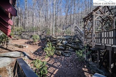 335 Cherry Drive Boone, NC 28607 - Photo 24 of 32 a backyard of a building with lots of trees