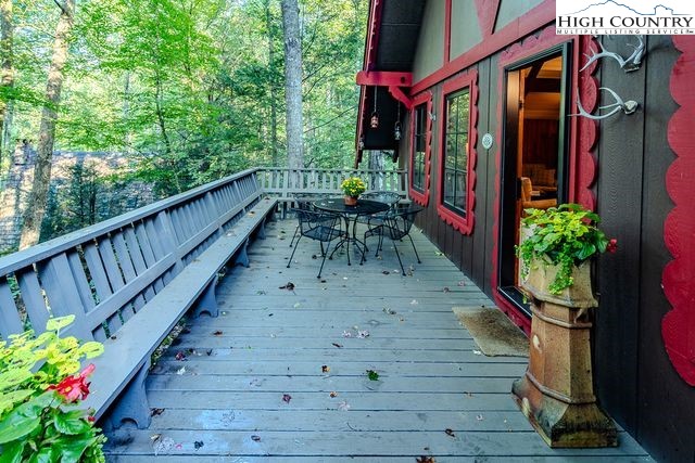 335 Cherry Drive Boone, NC 28607 - Photo 27 of 32 a view of a chairs and table on the wooden deck