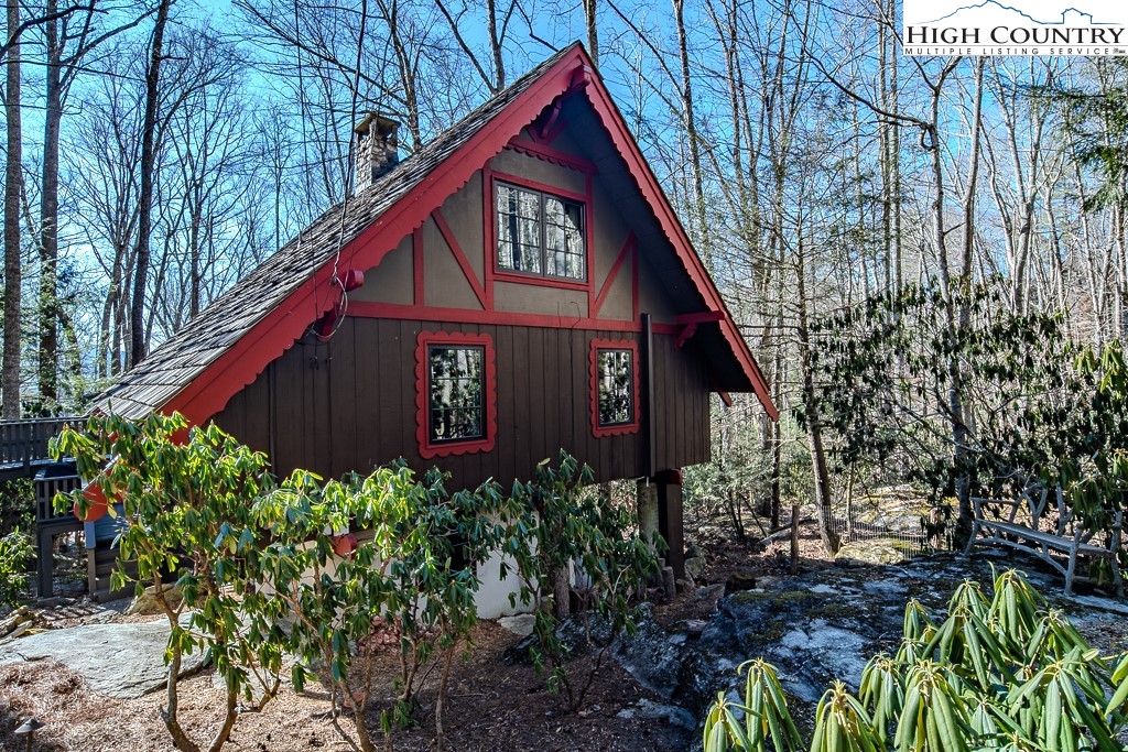 335 Cherry Drive Boone, NC 28607 - Photo 4 of 32 a view of a small house with a flower garden