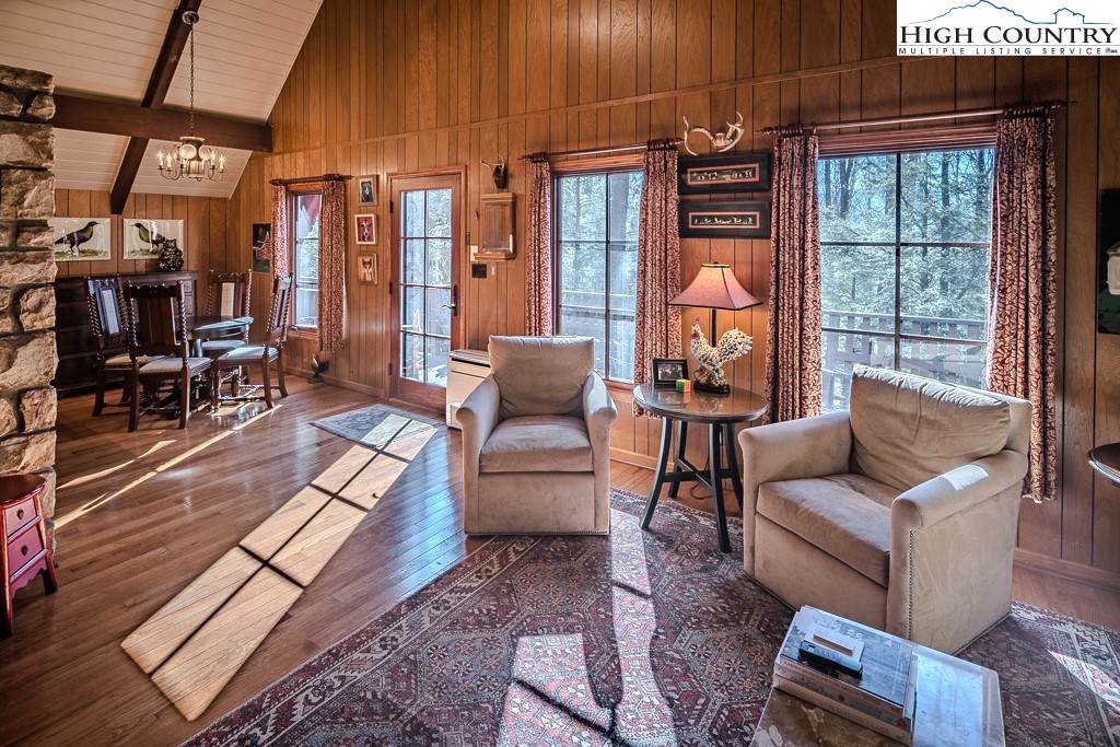 335 Cherry Drive Boone, NC 28607 - Photo 10 of 32 a living room with furniture a lamp and a fireplace