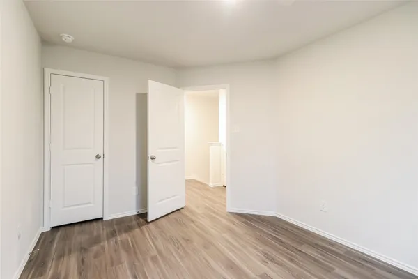 a view of an empty room and wooden floor