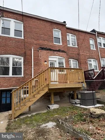 a view of a big house with wooden stairs