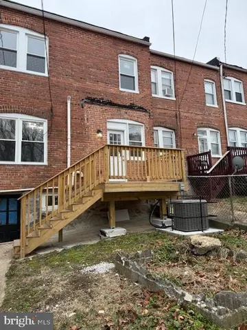 a view of a house with a yard and deck