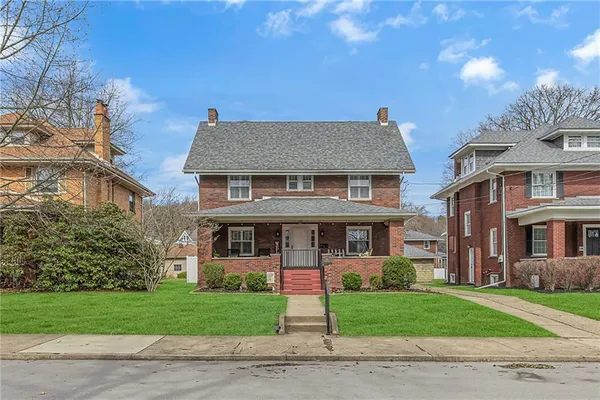 a front view of a house with a garden