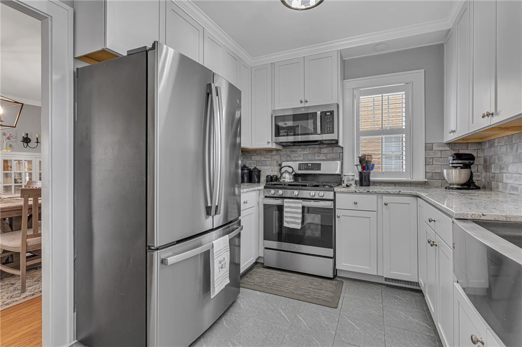 340 4th Street Beaver, PA 15009 - Photo 11 of 42 a kitchen with stainless steel appliances white cabinets and a refrigerator