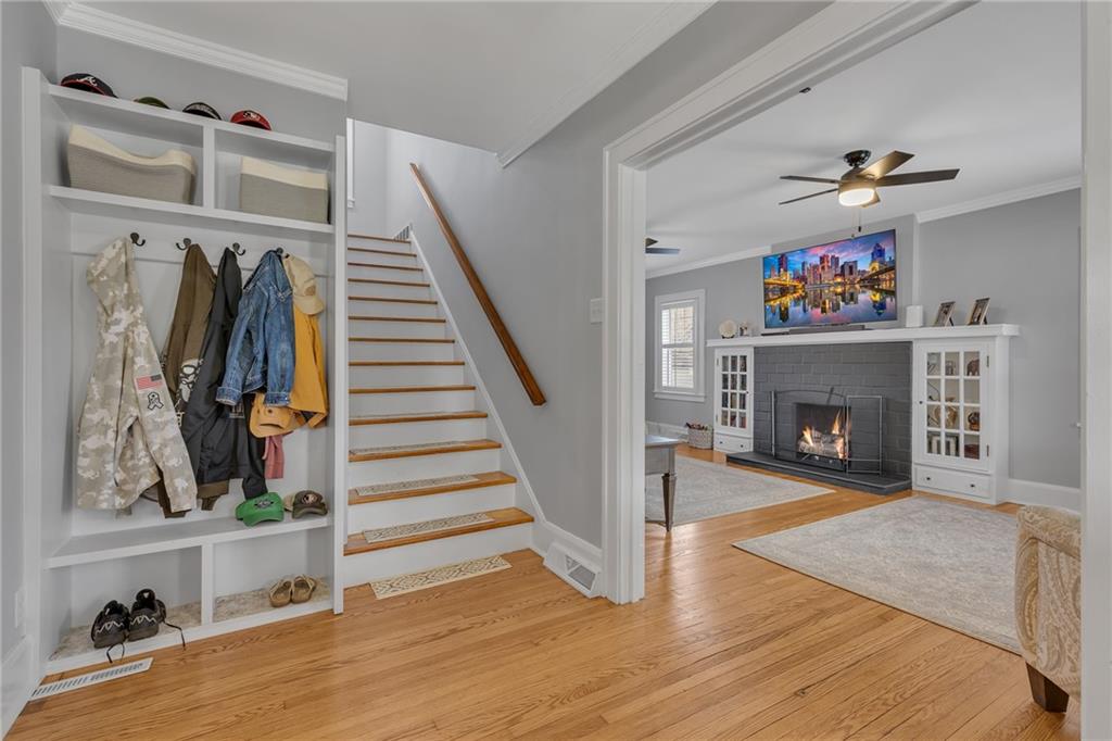 340 4th Street Beaver, PA 15009 - Photo 6 of 42 a view of a livingroom with wooden floor fireplace and staircase