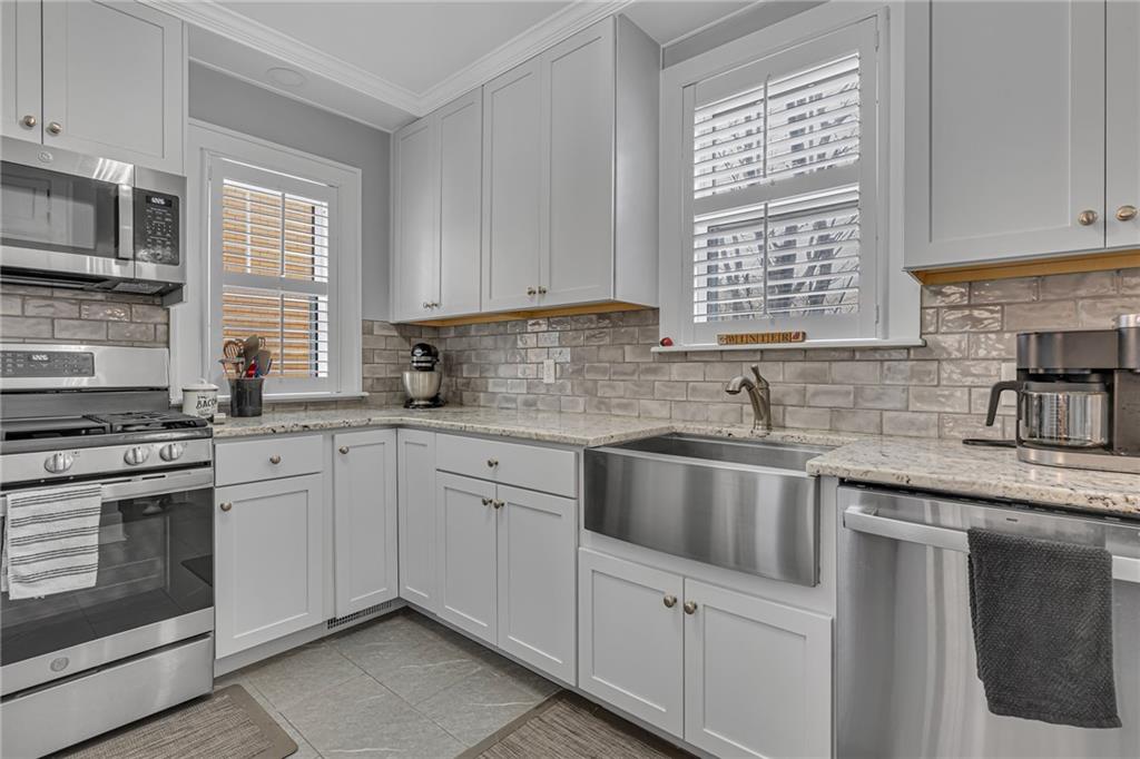 340 4th Street Beaver, PA 15009 - Photo 10 of 42 a kitchen with cabinets appliances a sink and a window